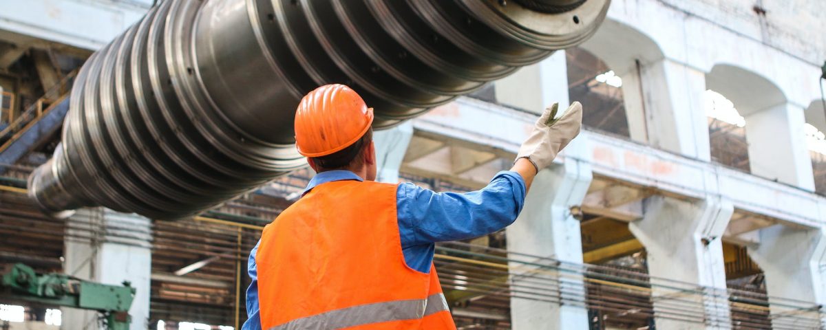 man standing near gray metal equipment