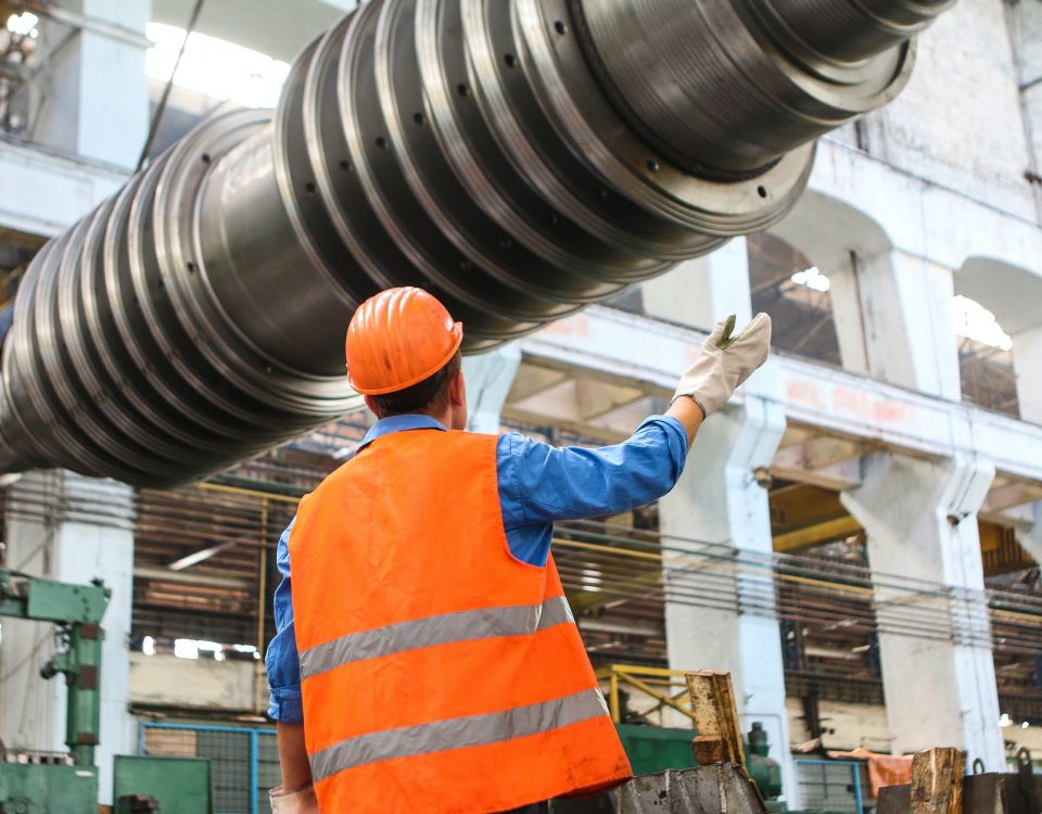 man standing near gray metal equipment