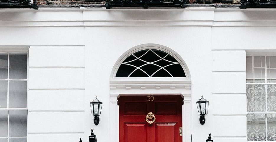 facade of residential building with red door