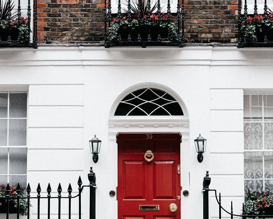 facade of residential building with red door